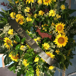 Large sunflower wreath with a black memorial ribbon and deer ornament