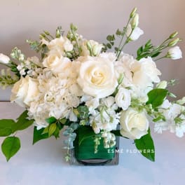 White rose and hydrangea arrangement in a glass vase