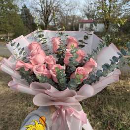 Pink rose bouquet with eucalyptus wrapped in pale pink paper