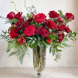 Red rose arrangement in a clear glass vase