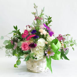 Mixed flower basket with pink and white blooms and butterfly accents