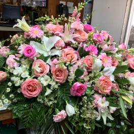 Large pink and white floral arrangement with roses and lilies
