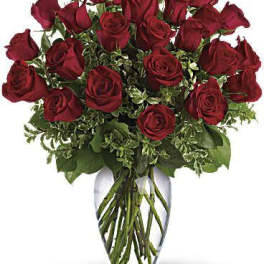 Arrangement of long-stem red roses in a clear glass vase