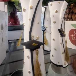 Graduation-themed decorative cylinders with caps and tassels