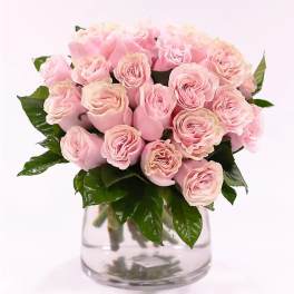 Pink roses arranged in a clear glass vase