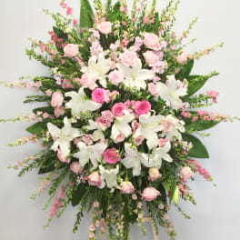 Large pink and white floral standing spray on an easel
