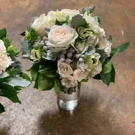 Bouquet of pale roses and white hydrangeas in a metal vase