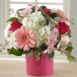 Pink and white mixed bouquet in a bright pink vase