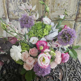 Mixed bouquet of pink and white flowers with purple blooms