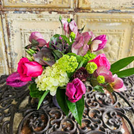 Bouquet of pink roses and purple blooms with green hydrangea