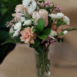 Pink and white bouquet in a clear glass vase