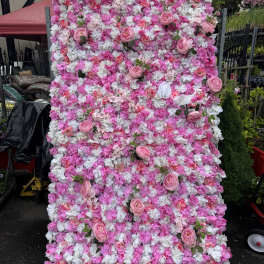 Pink and white floral wall with scattered roses