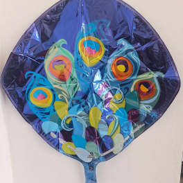 Peacock-shaped foil balloon with colorful feather patterns