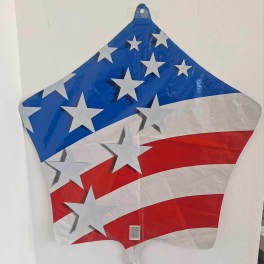 Star-shaped patriotic foil balloon with red, white, and blue stripes
