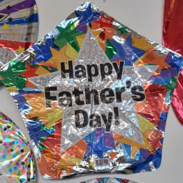 Star-shaped foil balloon reading Happy Father's Day.