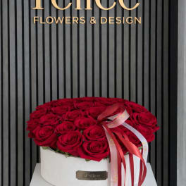 Round box of red roses with a ribbon bow