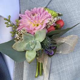 Pink boutonniere with a succulent and small accent flowers