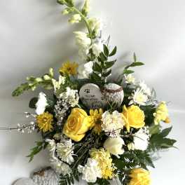 Yellow and white floral arrangement with memorial heart stones