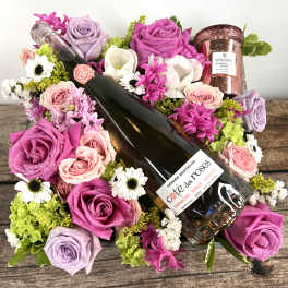 Bouquet with roses and a wine bottle, plus a rose-scented candle