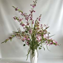 Pink and white flowers in a tall white vase