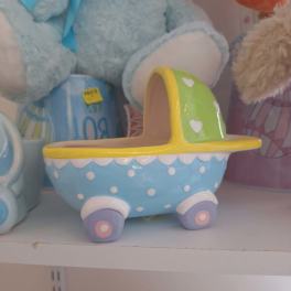 Pastel ceramic planter shaped like a baby carriage