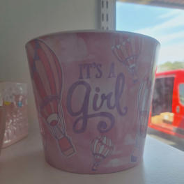 Pink pot with hot air balloons and the words "It's A Girl"
