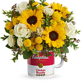 Bouquet of yellow sunflowers and white roses in a soup can mug