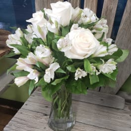 White roses and alstroemeria in a clear glass vase