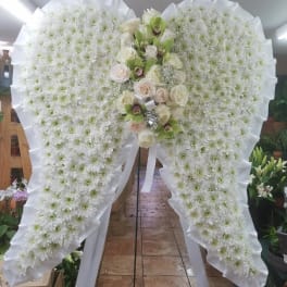 Large white floral standing spray with roses and orchids