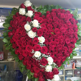 Heart-shaped rose arrangement with red and white roses