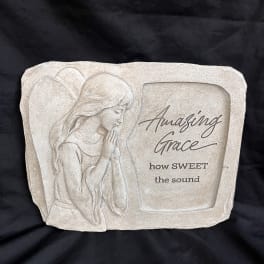 Beige memorial plaque with an angel relief and the words "Amazing Grace"