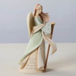 Angel figurine holding a staff, wearing a pale dress and scarf