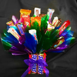 Candy bouquet of assorted chocolate bars with colorful cellophane and a purple bow base