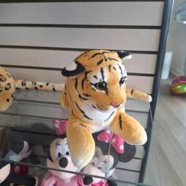Plush tiger toy on a glass shelf