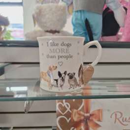 White mug with dog illustrations and the text "I like dogs more than people"