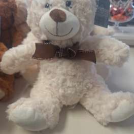 White plush teddy bear with a brown bow tie