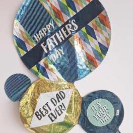 Three Father’s Day balloons with bold printed messages