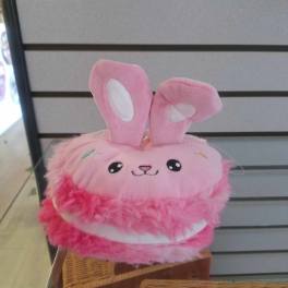 Pink plush bunny toy with tall ears and a smiling face