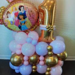 Princess-themed balloon display with a gold number 1 and pastel balloons