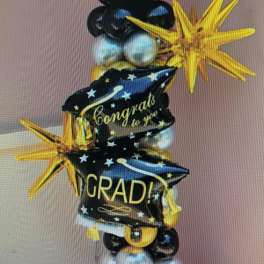 Graduation balloon tower with black, gold, and silver star balloons