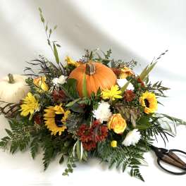 Autumn floral arrangement with pumpkins and sunflowers