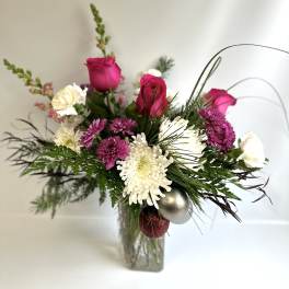 Bouquet of pink roses and white chrysanthemums in a glass vase
