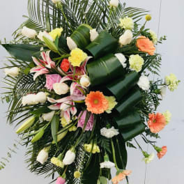 Large standing floral spray with white lilies, roses, and gerbera daisies