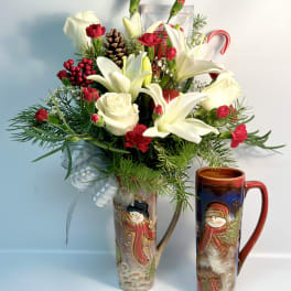 Holiday bouquet with white lilies, red carnations, and a pinecone in a decorative vase