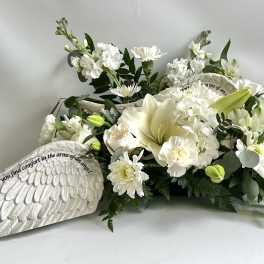 White sympathy floral arrangement with an angel wing plaque