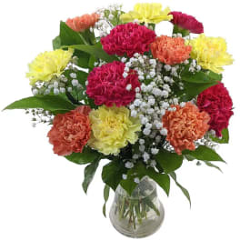Mixed carnations in a glass vase with baby's breath