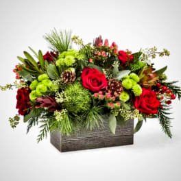 Red roses and green flowers in a rectangular wooden box