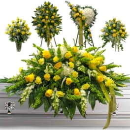 Yellow rose funeral spray on a white casket