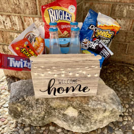 Snack basket with chips, candy, and bottled drinks in a welcome home box