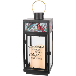 Black lantern with a cardinal and floral design and a memorial message